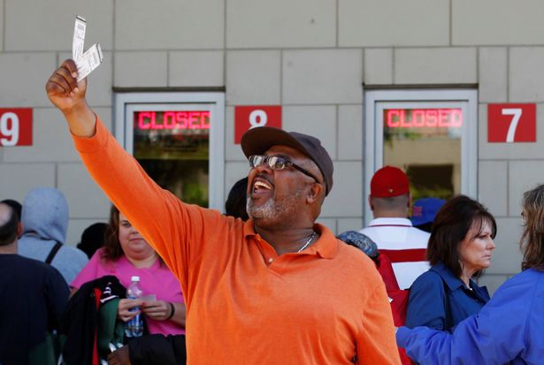 A-man-shows-his-tickets-to-the-late-Muhammad-Alis-memorial-service